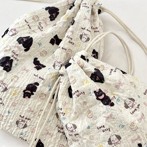 Detail of quilted drawstring storage bags with cute cartoon cat and dog patterns