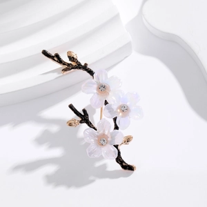 Elegant plum blossom brooch featuring black metal branches and white rhinestone flowers