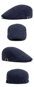 Detailed side view of dark blue herringbone flat cap with silver metal buckle adjustment