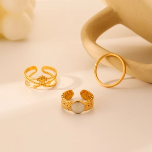 Three-piece gold-tone titanium steel ring set with sunburst and leaf texture designs