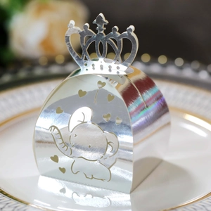 Macro shot of silver hollow gift box with crown top and elephant heart patterns