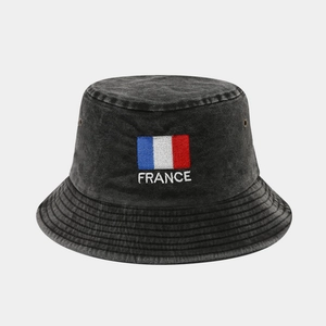 Detail of vintage washed black cotton bucket hat with embroidered France flag and text