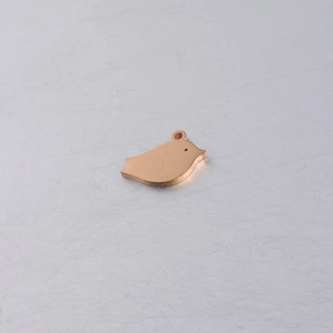 Detail of rose gold bird pendant with smooth polished finish for DIY jewelry crafting
