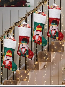 Detail of Christmas nutcracker stockings in red and green hanging on stairs railing