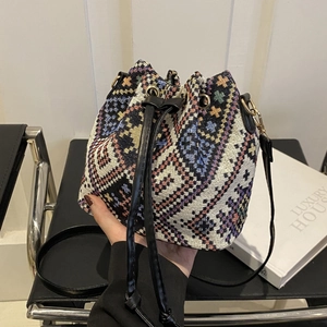 Retro multi-colored woven bucket bag with black leather straps and gold metal hardware