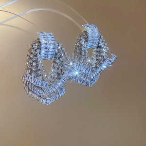 Macro view of silver fringe earrings with shimmering tassels and cubic zirconia stones