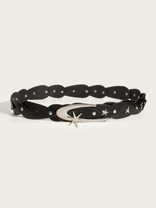Detail of black leather belt featuring silver star and moon buckle with metal studs