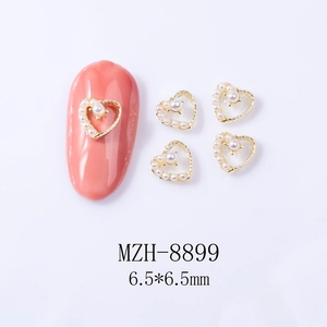 Detail of 6.5mm hollow heart nail art charm with golden alloy and pearl inlay