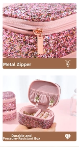 Macro detail of pink glitter jewelry box featuring a sturdy gold zipper and velvet lining
