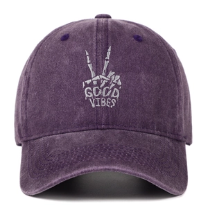 Detailed macro view of Good Vibes bone gesture embroidery on purple washed cotton cap