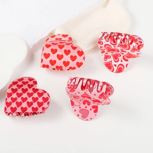 Pink and red heart-shaped hair claw clips set for women on white background