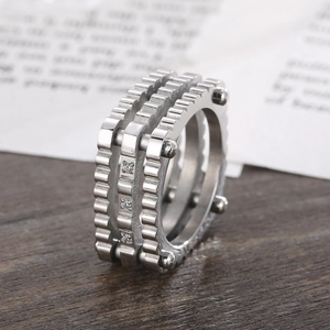 Macro shot of industrial titanium ring with triple gears and inlaid cubic zirconia