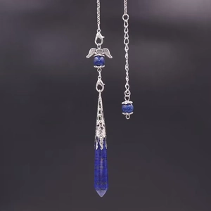 Macro detail of hexagonal lapis lazuli crystal pendant with silver angel wing charm