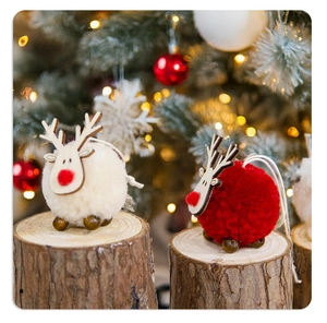 Close-up of red and beige felt reindeer ornaments with bells for Christmas decoration