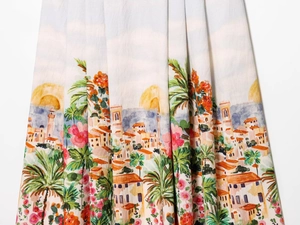 Detailed view of Mediterranean style fabric with colorful coastal landscape and floral prints