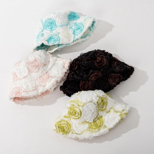 Detail view showing four plush bucket hats with 3D floral rose textures in various colors