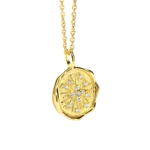Elegant gold celestial coin necklace with sparkling starburst zircon pendant on white base