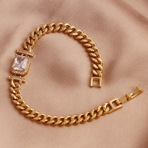 Macro shot of gold-plated cuban link bracelet featuring a rectangular white zircon stone