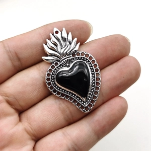 Gothic silver alloy heart wing pendant featuring a black gemstone with fire flame detail
