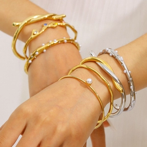 Stacked 18K gold and silver plated bangles with pearls, diamonds and colorful zircons