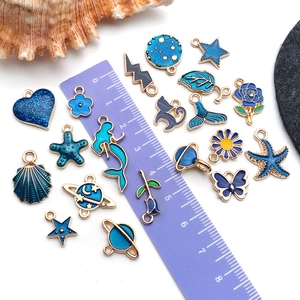 Blue enamel alloy charms set for DIY jewelry making with ruler for size comparison