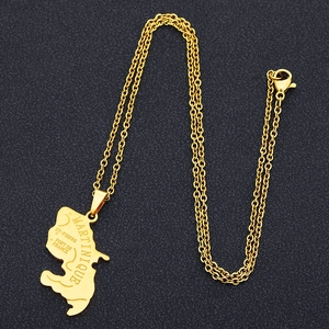 Detailed close-up of golden Martinique map pendant with engraved city names on chain