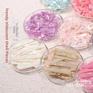 Detailed view of iridescent aurora shell nail art flakes in diverse pastel colors