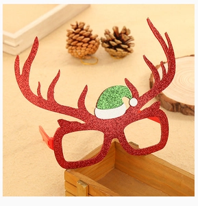 Close-up of sparkling red reindeer antler glasses frame with a mini Christmas hat detail