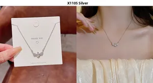 Detailed view of silver bow necklace with zircon wings on card and worn by model