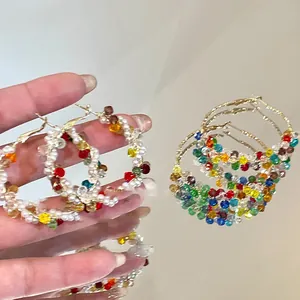 Vue détaillée des boucles d'oreilles créoles avec perles colorées et accents de cristal
