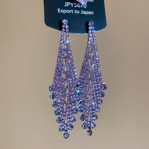 Detail of purple rhinestone tassel earrings with V-shaped crystal fringe design