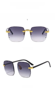 Detail view of gold frameless square sunglasses with gradient gray lenses and metal accents