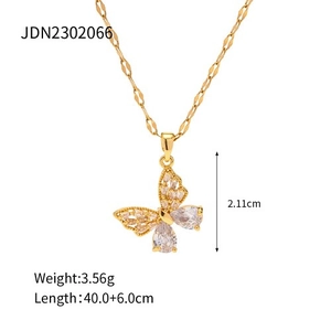 Detail view of 18k gold butterfly necklace pendant with crystal zircon stone inlays