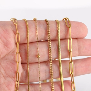 Detail showing 18k gold plated stainless steel chain styles including paperclip and snake links