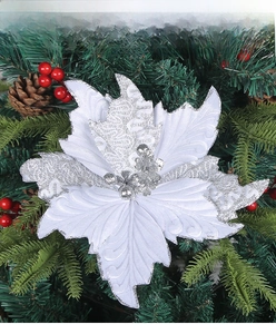 Detail of multi-layered white poinsettia ornament with silver glitter on Christmas tree