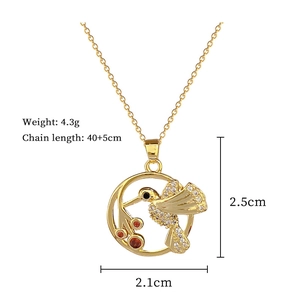 Close-up of golden hummingbird pendant necklace with white zircons and dimensions display