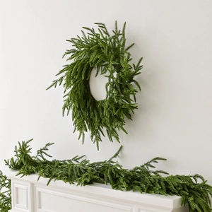 Realistic Norfolk pine Christmas wreath and garland set displayed on white wall and mantel