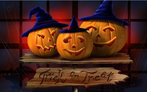Detail of Halloween pumpkin lanterns with wizard hats and wood Trick or Treat sign