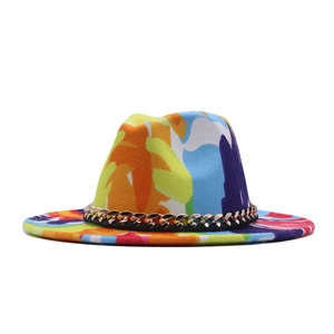 Close-up of colorful graffiti fedora with a wide brim and decorative gold chain band