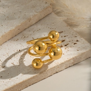 Fashionable multilayer gold beaded ring with geometric wrap design on a stone tray