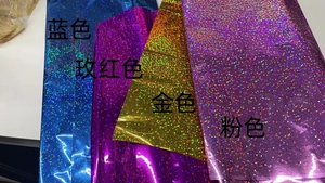 Detail of laser glitter film rolls in blue rose red gold and pink for party decor