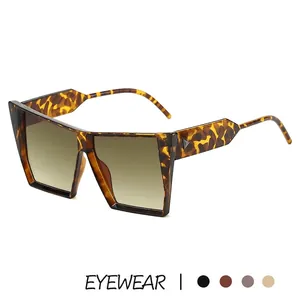 Oversized cat eye sunglasses with leopard print frame and triangular rivets