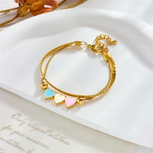 Elegant double-layered gold bracelet featuring blue and pink enamel heart charms