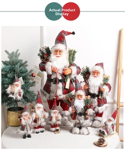 Standing Santa Claus figures in red and grey plaid outfits with gift bags and skis