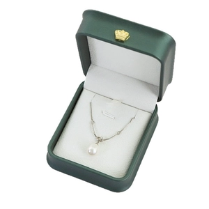 Elegant white pearl pendant necklace in a deep green velvet jewelry gift box