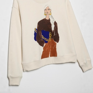 Cream crewneck sweatshirt featuring a stylish fashion girl illustration with a blue bag
