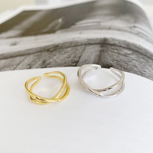 Detailed shot of gold and silver S925 sterling silver crisscross irregular open rings