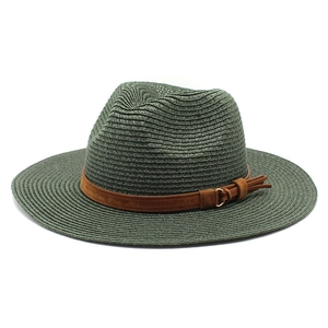 Detail of dark green straw fedora hat featuring a brown faux suede band with tassel and buckle