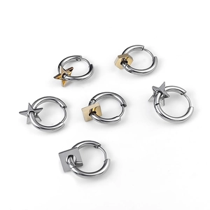Detail shot of stainless steel hoop earrings with star and geometric charms on white background