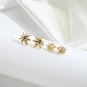 Golden maple leaf earrings set with sparkling zircon crystals for a vintage women's style